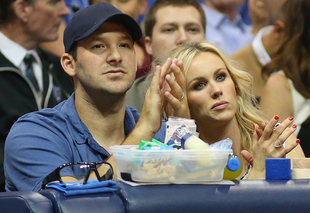 Tony and Candace Romo at a basketball came, applauding