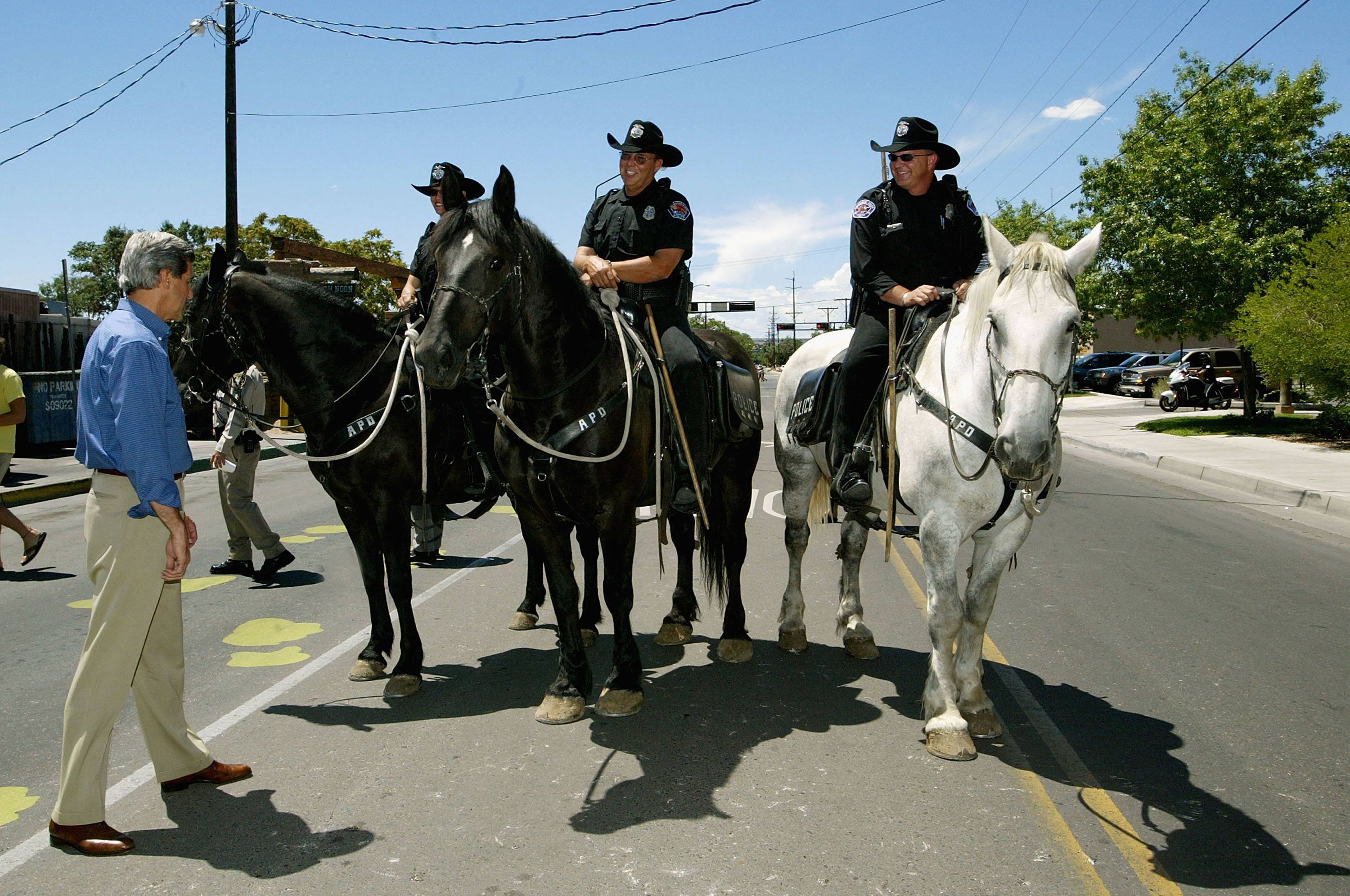 John Kerry greets a group of mounted Albuquerque police officers