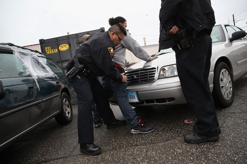 New London police officers search a suspect