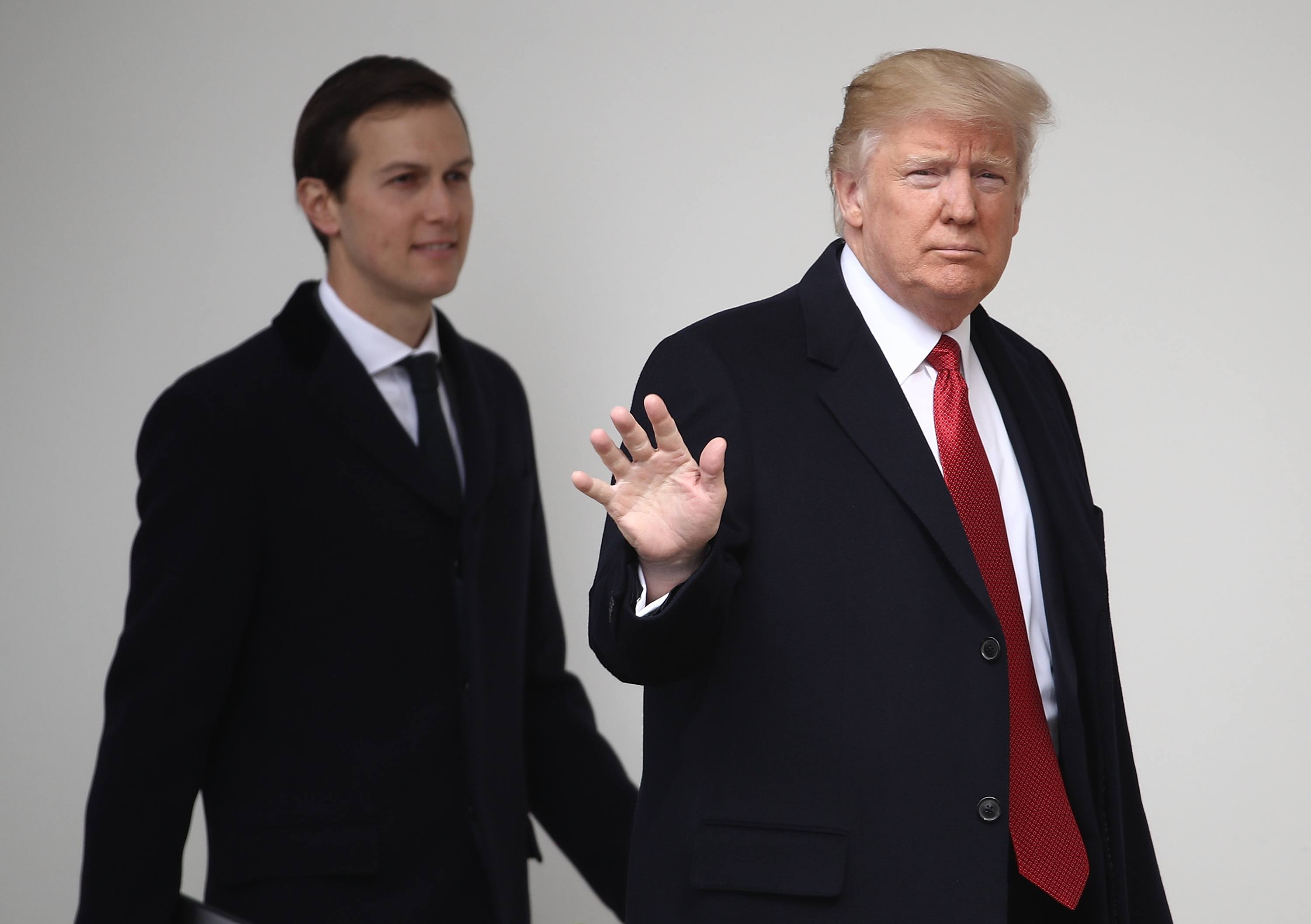U.S. President Donald Trump waves while walking to a waiting Marine One helicopter with son-in-law and senior advisor Jared Kushner