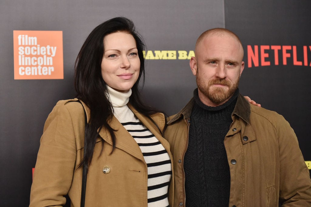 Laura Prepon and Ben Foster smiling on the red carpet together for a Netflix premiere