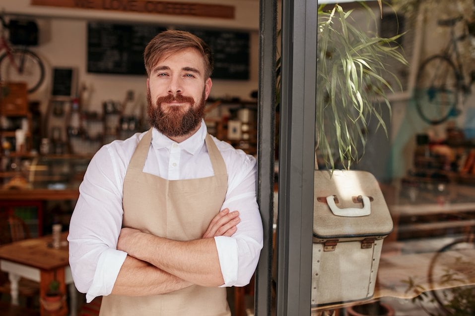 man in apron smiles