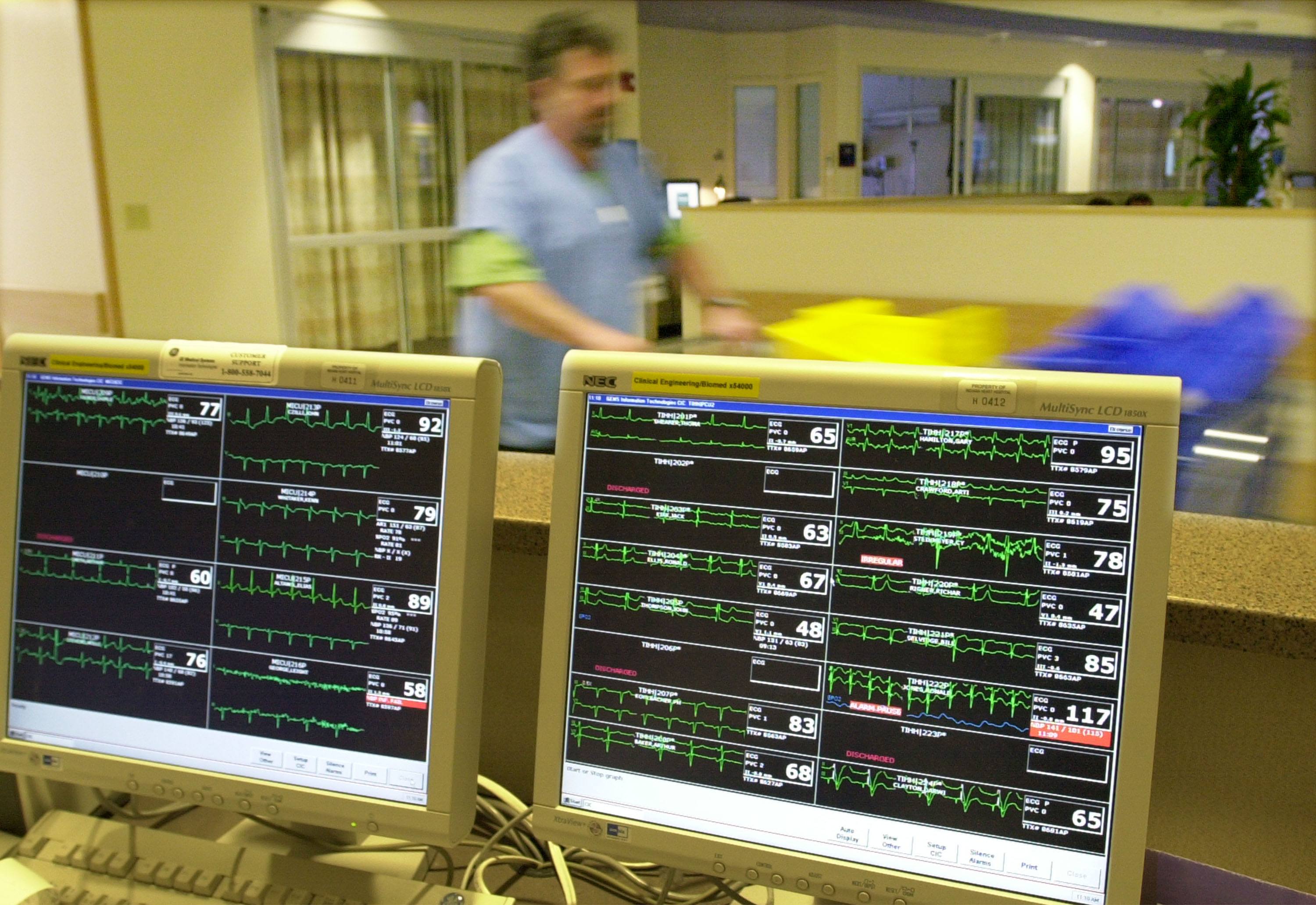 A hospital worker pushes a cart past the patient information center at the Indiana Heart Hospital