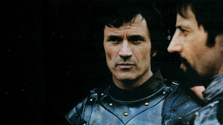Luc Simon and Vladimir Antolek-Oresek in armor looking troubled in Lancelot of the Lake