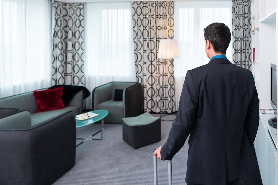 Businessman at arrival in room of design hotel Businessman at arrival in room