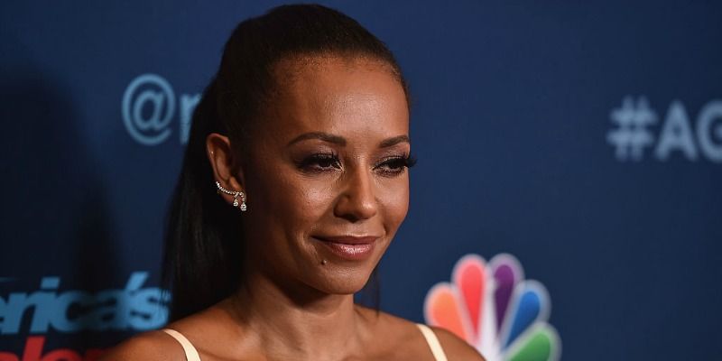 This is a close up of Mel B smiling and posing on the red carpet.