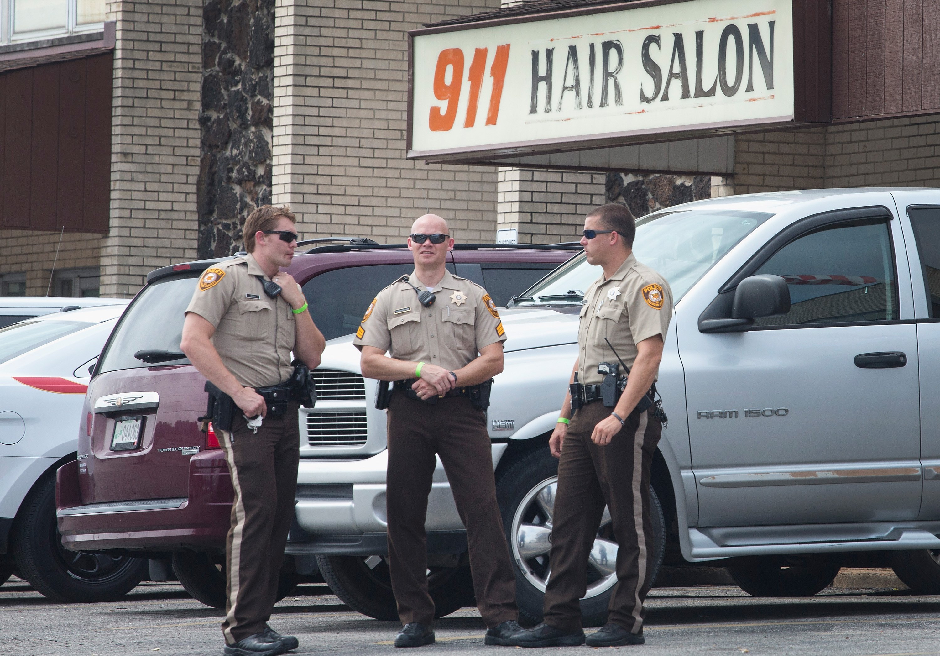 Police stand guard outside a hair salon in Ferguson