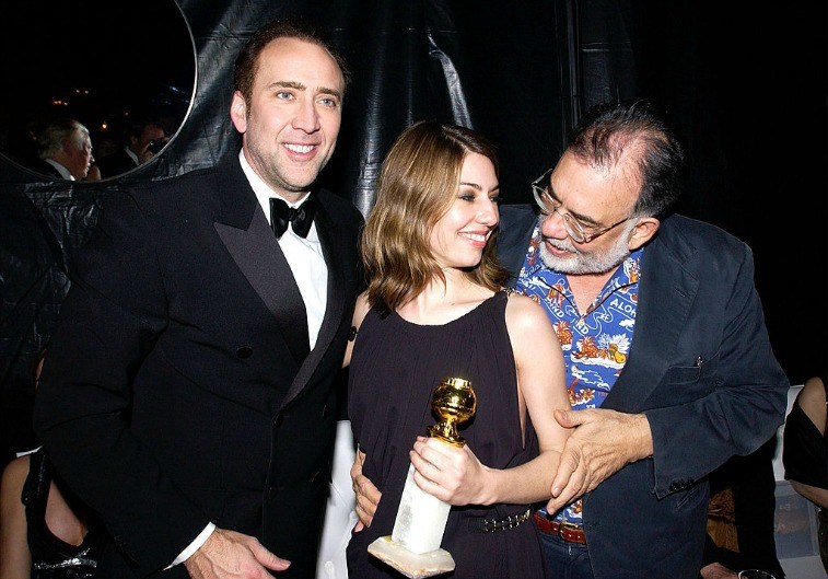 Nicolas Cage, Sofia Coppola, and Francis Ford Coppola pose for the cameras with a Golden Globe