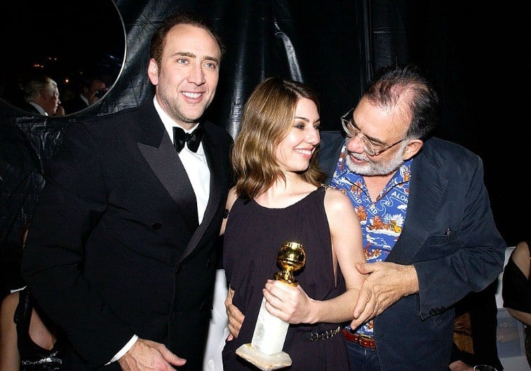 Nicolas Cage, Sofia Coppola, and Francis Ford Coppola pose for the cameras with a Golden Globe 