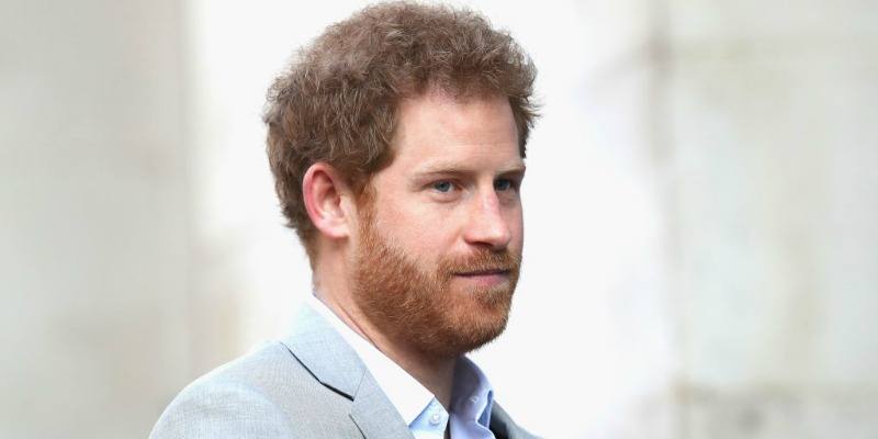 Prince Harry is in a light grey suit.