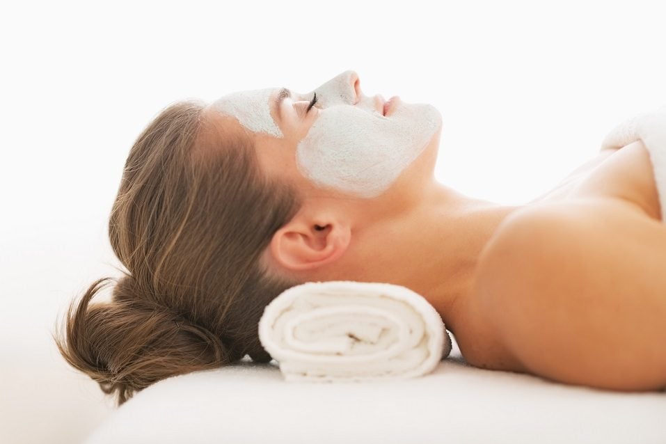 young woman with revitalising mask on face