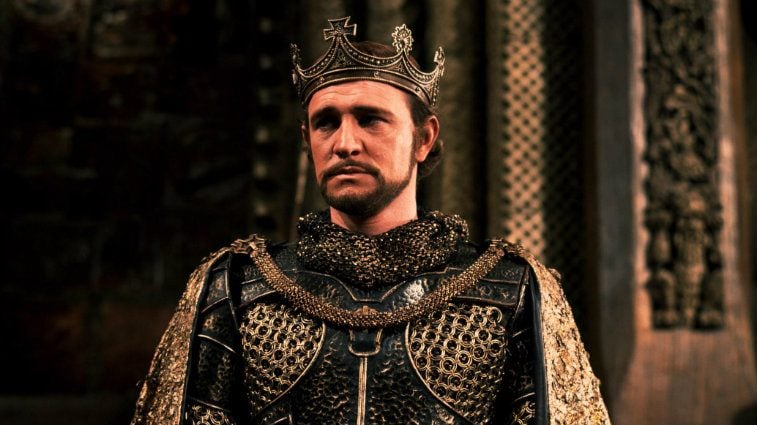 Richard Harris wearing armor and a crown while looking troubled in Camelot