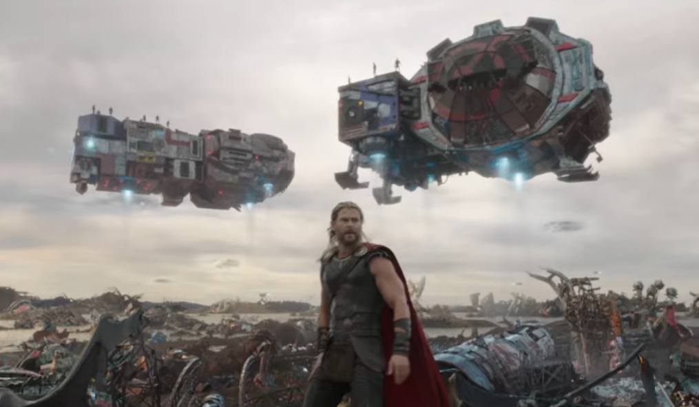 Thor in an alien junkyard, with various ships in the background