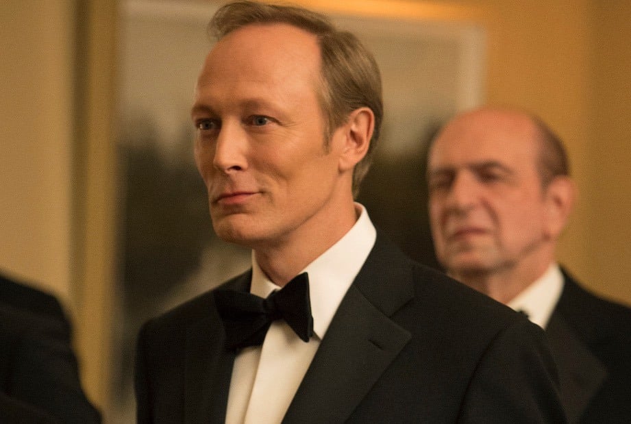 Lars Mikkelsen wearing a tuxedo, smiling, and looking to the left of the frame