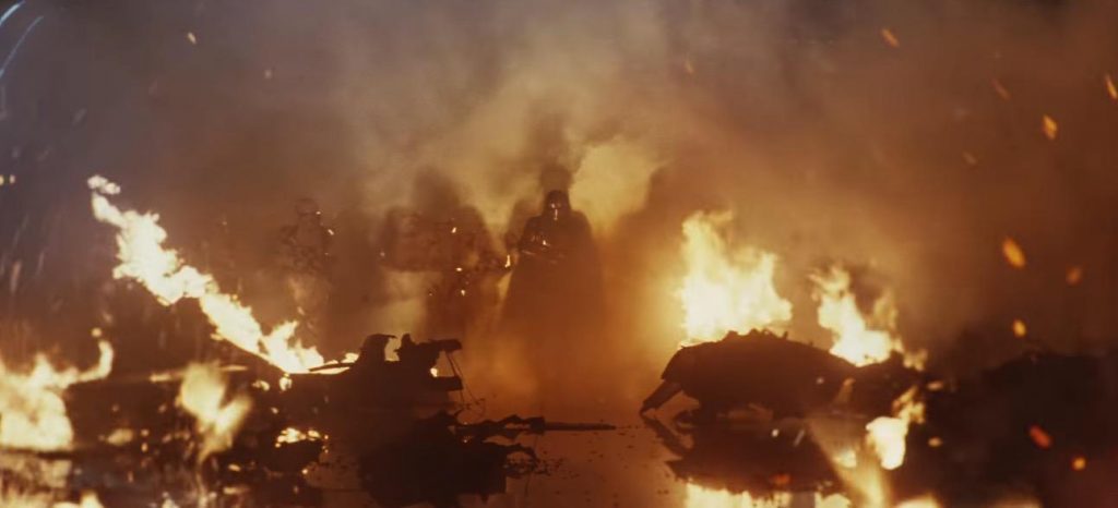 Phasma and Stormtroopers walking through a burnt ruin