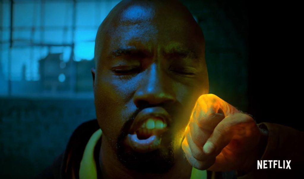 The Iron fist punches Luke Cage in the cheek