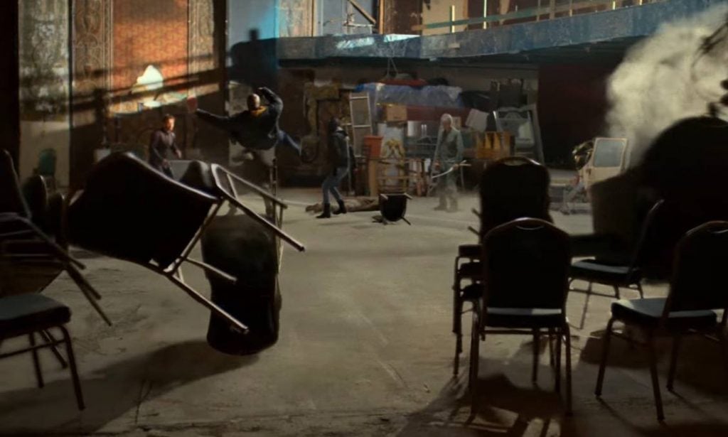 The Defenders in an abandoned theater, getting thrown back by an unseen force