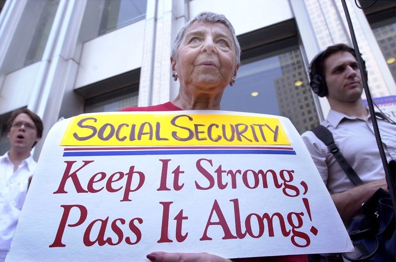 A protester holds a sign supporting social security
