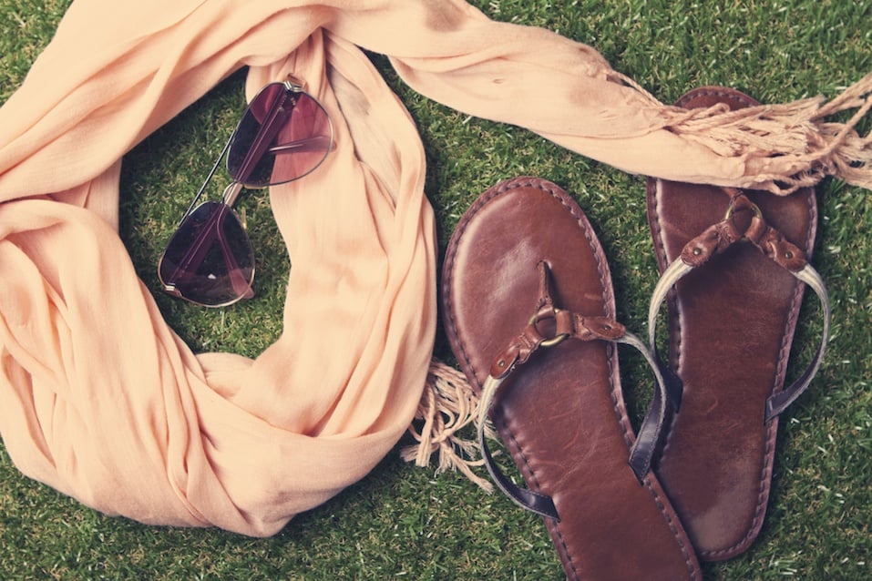Spring or summer womens fashion accessories lying on grass