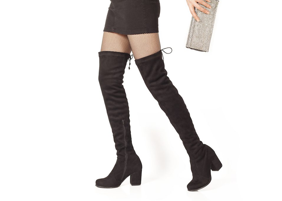 Woman legs in black suede boots