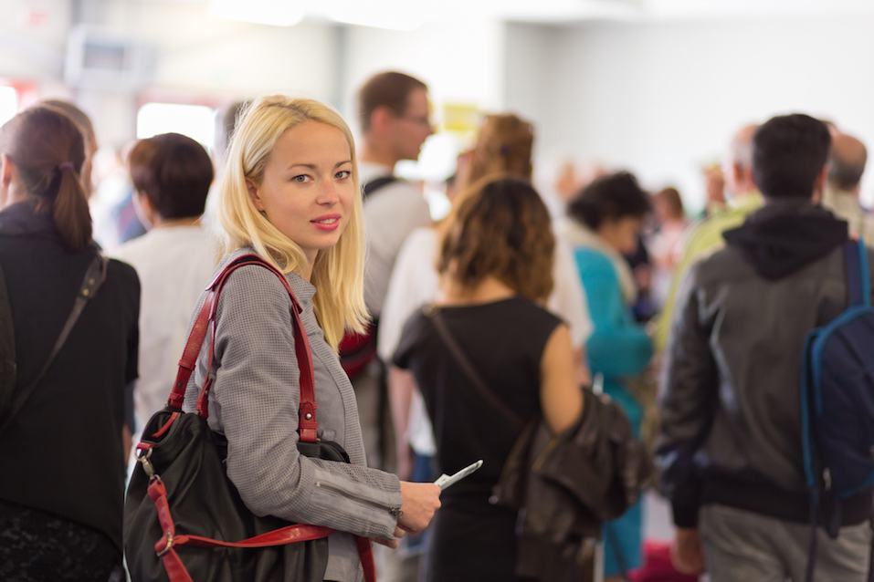 Lady standing in a long queue to board a plane Lady standing in a long queue to board a plane