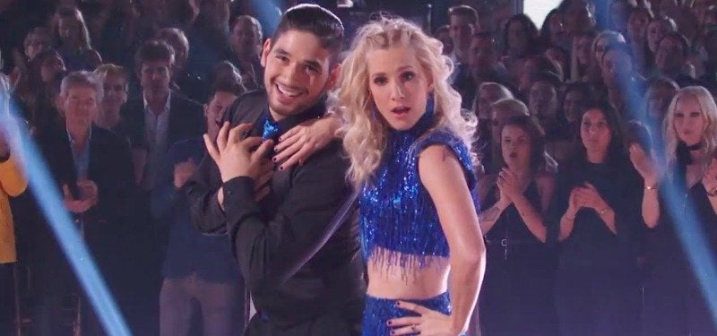 Ala Bersten has both hands over his heart as Heather Morris leans on him while dancing on the show.
