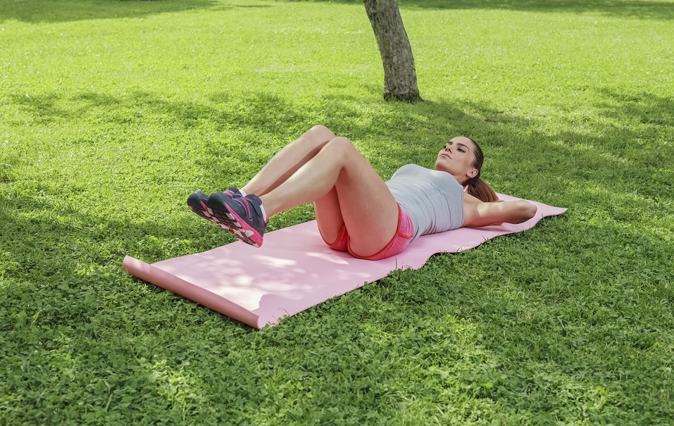 Woman lying on pilates mat