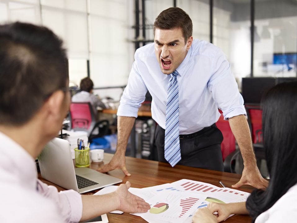 executive yelling at two workers