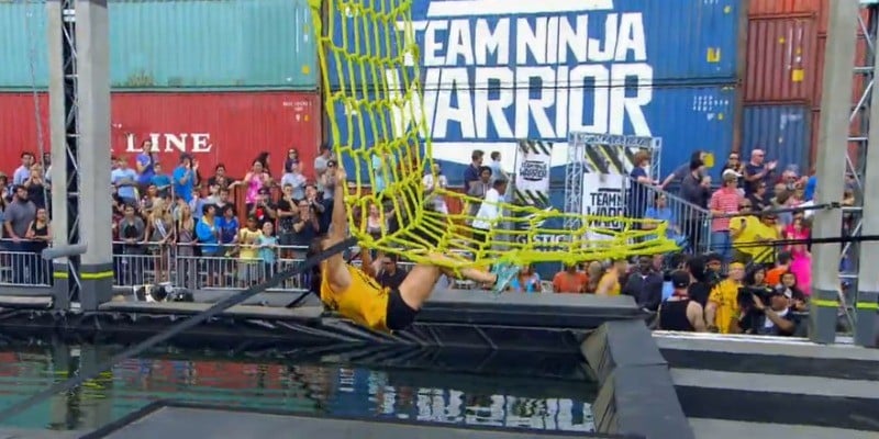 Erica Cook is climbing on a rope course.