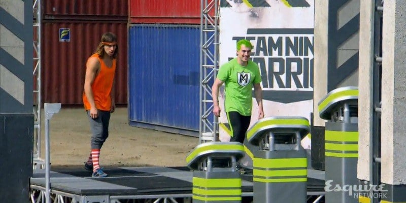 Jake Murray and Adam Grossman are in a runner's stance on the course of Team Ninja Warrior.