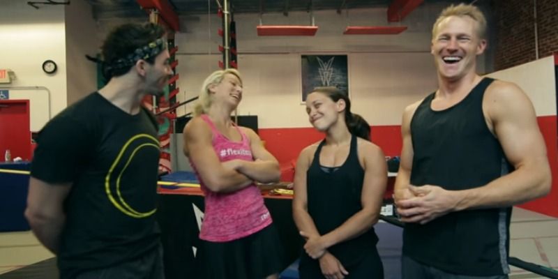 Jessie Graff, Drew Dreschsel, Erica Cook, and Evan Dollard talk in front of a ninja warrior gym.