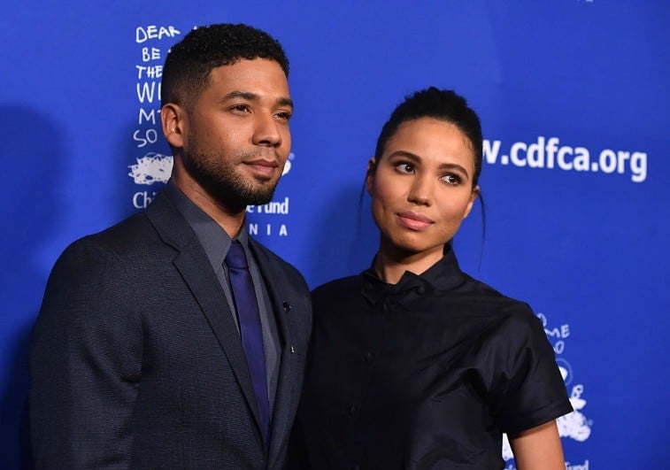 Siblings Jussie Smollett and Jurnee Smollett-Bell pose in front of a blue backdrop