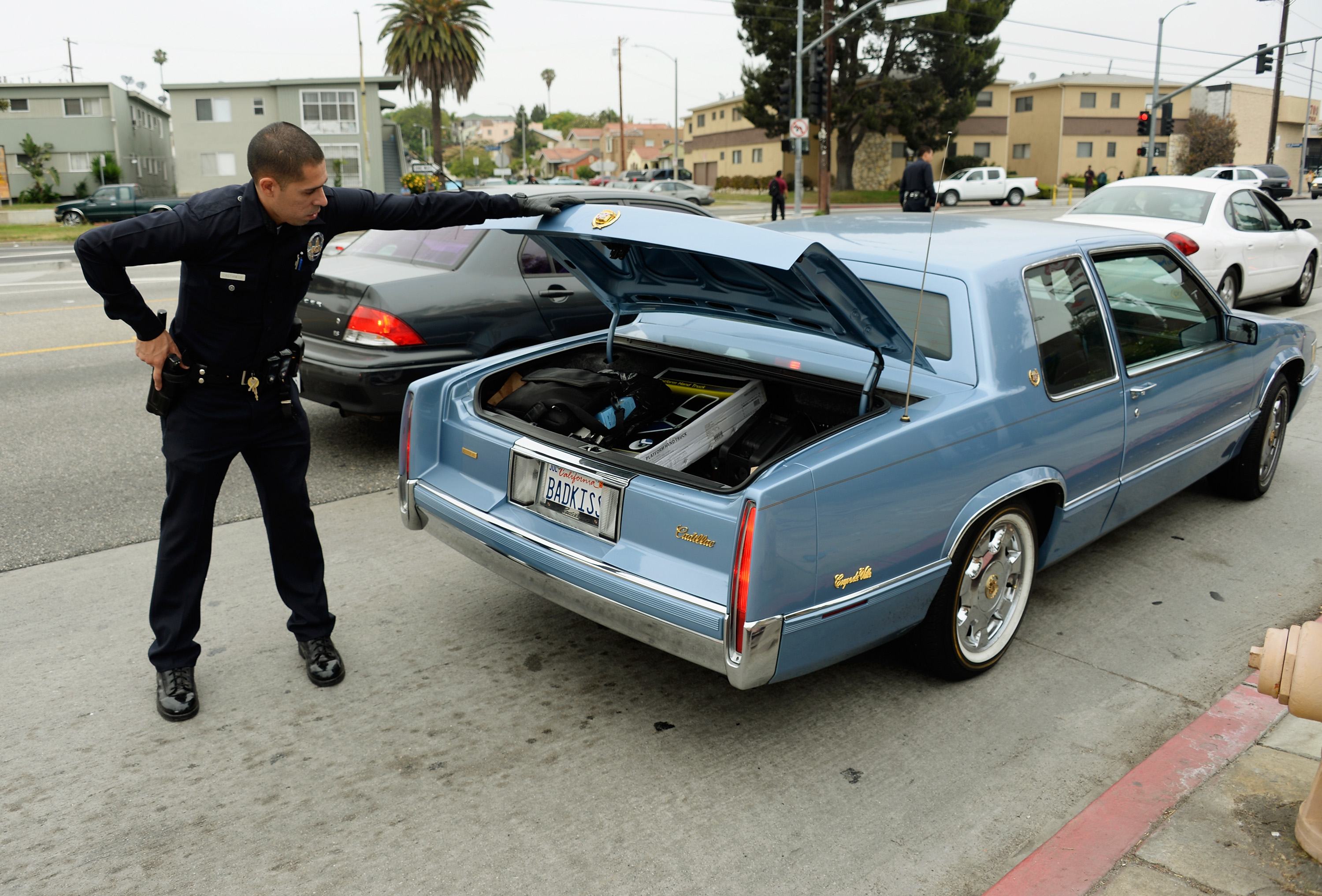Los Angeles Police Department officers search cars