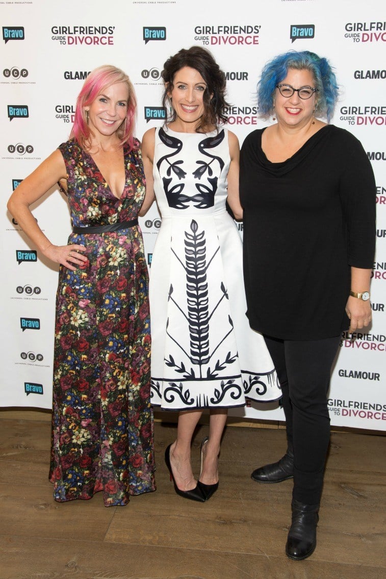 Marti Noxon, Lisa Edelstein, and Jenji Kohan in front of sign for Girlfriend's Guide to Divorce
