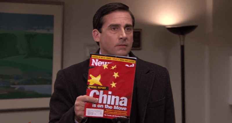 Scene from "The Office" with Michael Scott holding up magainze that says "China is on the move"