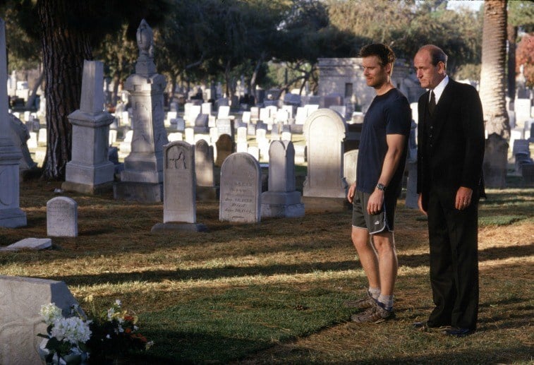 Actors Peter Krause and Richard Jenkins stand in a graveyard in a scene from 'Six Feet Under'