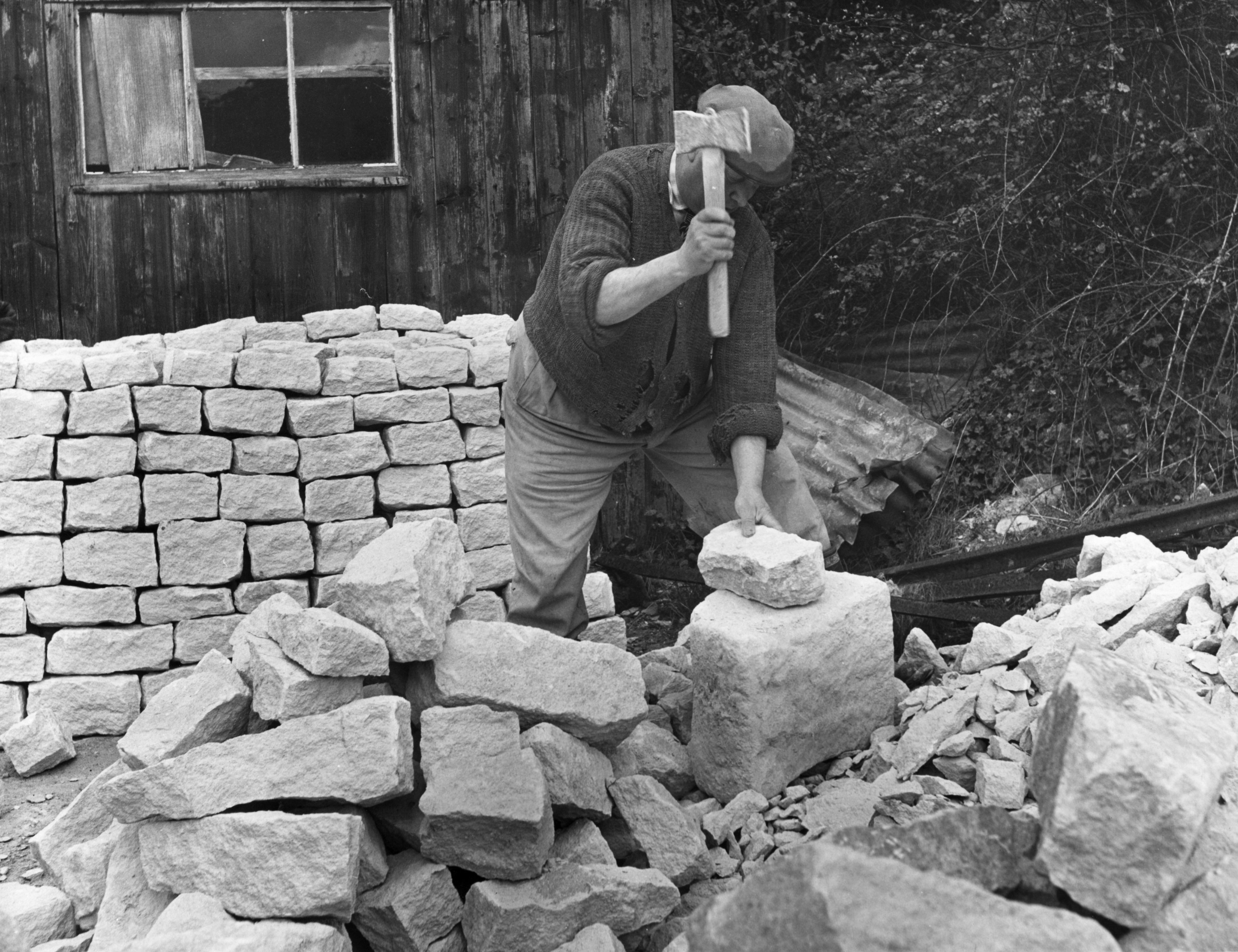 A mason shaping Cotswold stones