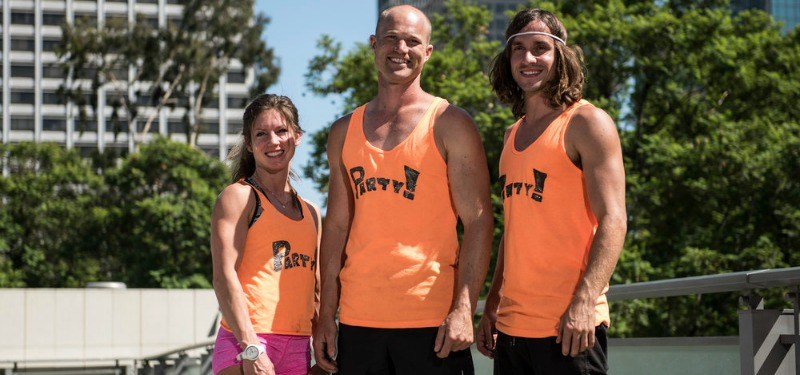 Jennifer Tavernier, Brian Arnold, and Jake Murray pose together in orange uniforms.