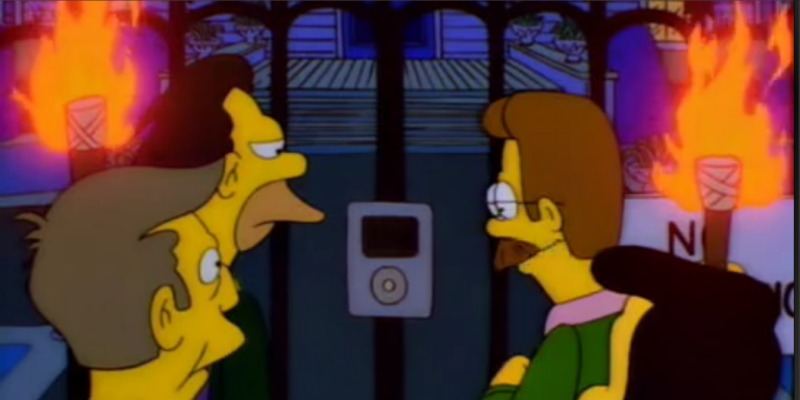 An angry mob with pitchforks are at a gate looking an intercom that looks like an iPod.