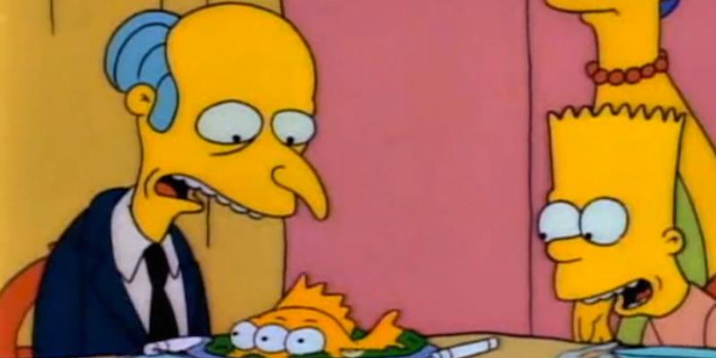 Mr. Burns is looking down at a platter that has the three-eyed fish on The Simpsons.