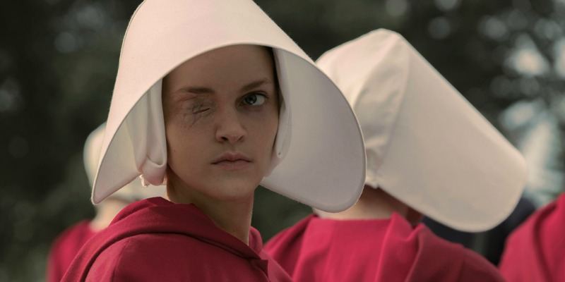 Janine looks to the side and has one eye sewed shut in The Handmaid's Tale.