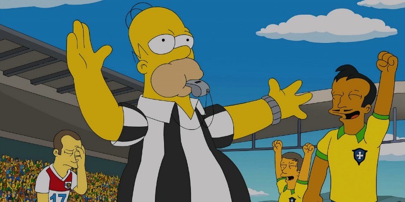 Homer is in a referee uniform and is blowing a whistle on a soccer field.