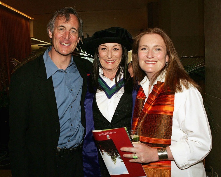 Siblings Tony, Anjelica, and Allegra Huston smiling and posing together