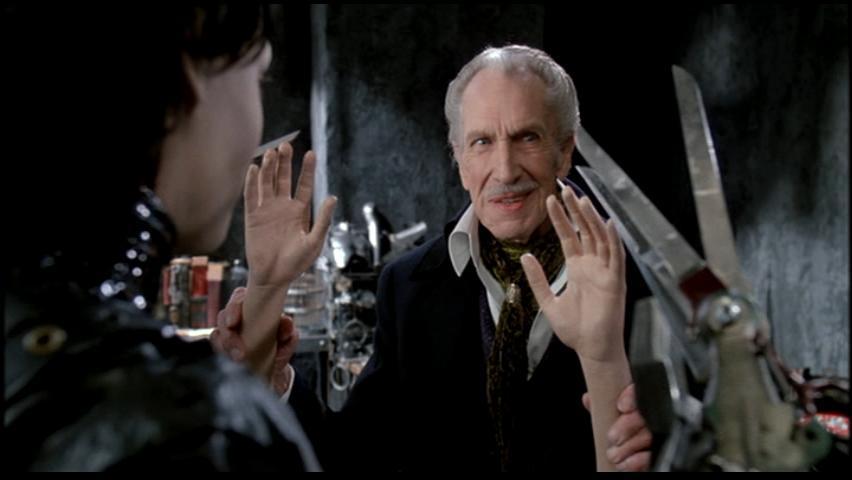 Vincent Price holds up dismembered hands and smiles in Edward Scissorhands
