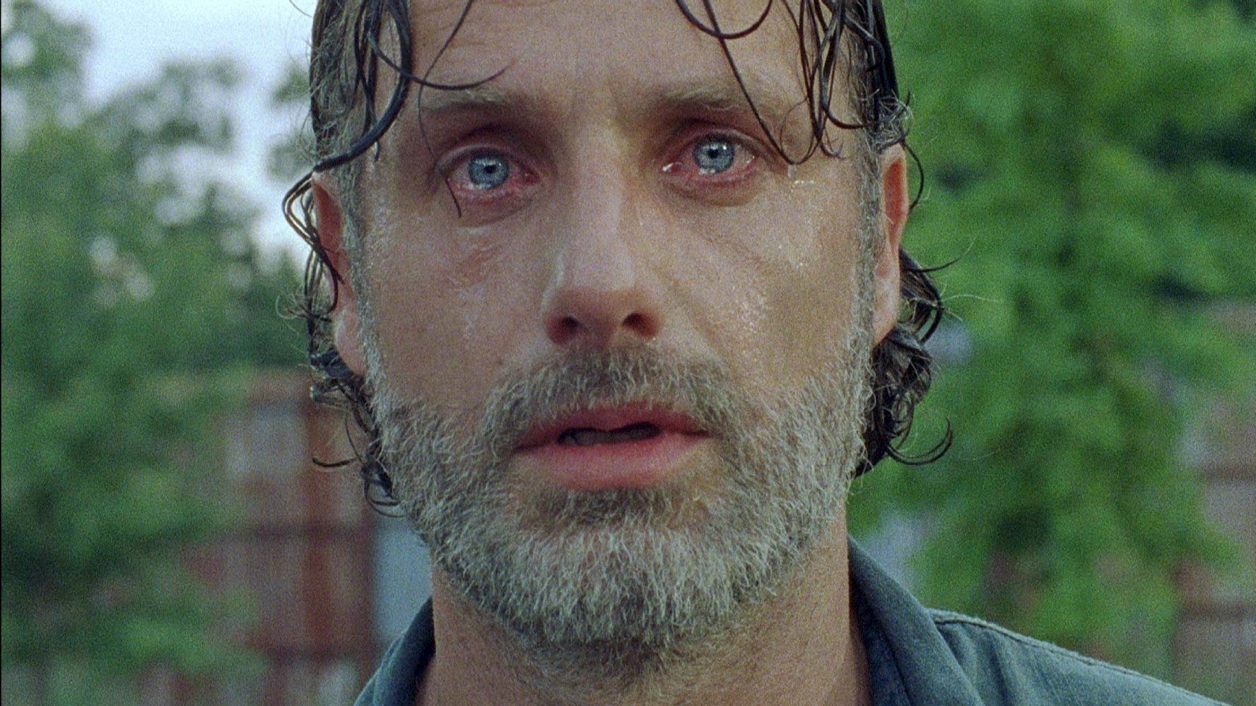 Rick, looking sweaty and disheveled, looks directly into the camera