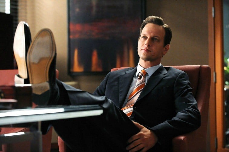 Josh Charles as Will Gardner in a suit sitting in an office chair with his feet up on The Good Wife