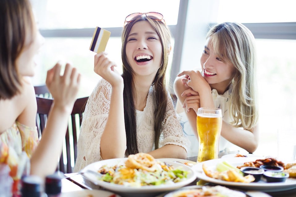 young group showing credit card