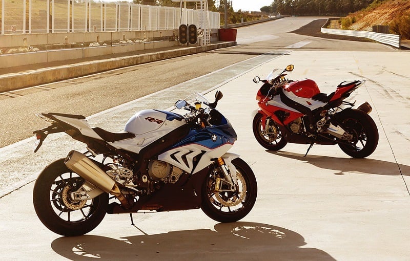 Pair of 2016 BMW S 1000 RR motorcycles parked on the race track at sunset
