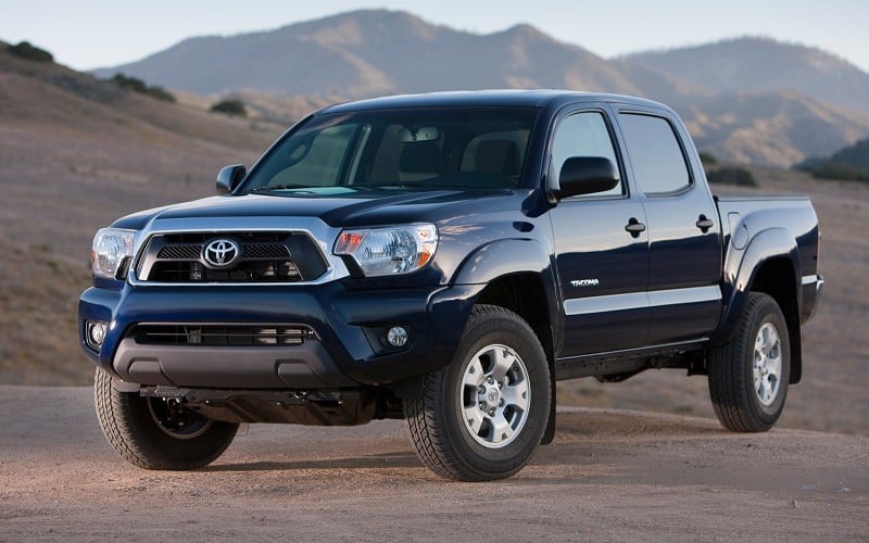 Front three quarter view of 2012 generation Toyota Tacoma in blue