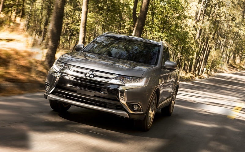 View of 2017 Mitsubishi Outlander driving through wooded area